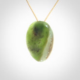 This is a unique pāua pendant, hand carved from New Zealand Jade. The cord is a creme colour and is length adjustable. This is delivered to you with Express Courier.